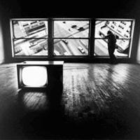 Surreal photograph of studio space with an intersection of traffic displayed in the window panes
